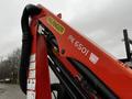 Red Palfinger PK 6501 crane attachment mounted on a truck with visible hoses and controls