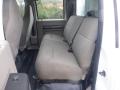 A 2009 Ford F-450 SD with a beige cloth bench seat in the rear cab area showcasing seating for three with seat belts attached