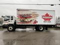 A 2006 GMC F7B042 truck is displayed with a large advertisement featuring sandwiches and the Dempster's logo on its side