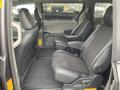 Interior view of a 2013 Toyota Sienna showing two black leather captain's seats with fabric inserts facing forward