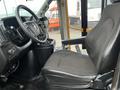 A black fabric driver's seat is positioned in the driver's area of a 2017 Chevrolet Express with a steering wheel and dashboard controls visible