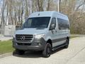 A 2019 Mercedes-Benz Sprinter van with a sleek silver exterior and black accents parked on a concrete surface