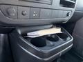 A 2009 GMC Savana cup holder with a book resting on top of it