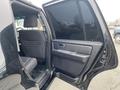 A 2017 Ford Expedition with an open rear door revealing the interior seats and door panel