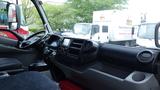 Interior view of a 2016 Hino 195 truck showing the steering wheel dashboard and driver seat with various controls and storage compartments