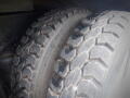 Close-up of two rugged tires from a 2008 International 7400 showcasing deep treads and a heavy-duty design