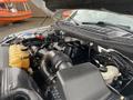 Close-up view of the engine compartment of a 2017 Ford F-150 showing the engine components and fluid reservoirs