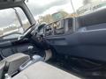 Interior view of a 2008 Hino 268 truck featuring a dashboard with controls gear shift and seating area