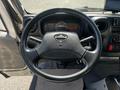 Steering wheel of a 2020 Hino 195 with control buttons and dashboard display visible in the background