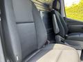 Two black fabric seats in the front of a 2022 Mercedes-Benz Sprinter van with a simple interior design