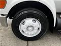 Close-up of a white wheel with a Michelin tire on a 2008 Ford F-750 showcasing the hub and lug nuts