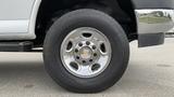 A close-up of the wheel of a 2017 Chevrolet Express Quigley 4x4 featuring a shiny chrome rim and a Continental tire labeled VancoTourSeason