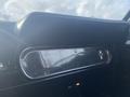 Interior view of a 1966 Ford Mustang dashboard featuring a chrome and black panel with the Mustang logo