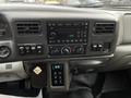 Dashboard of a 2008 Ford F-750 featuring radio controls climate controls and gearshift with illuminated indicators and various switches