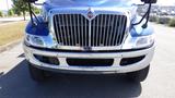 Front view of a blue 2012 International DuraStar 4300 with a chrome grille and bumper