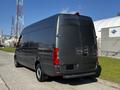 A 2021 Mercedes-Benz Sprinter van with a sleek gray exterior is shown from the rear angle highlighting its modern design and large cargo space