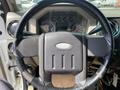 Steering wheel and dashboard of a 2010 Ford F-550 showing instrument panel and control buttons