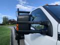 A white 2013 Ford F-450 SD with a black side mirror and an orange indicator light visible on the mirror