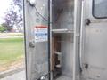 Interior view of a 2007 Morgan Olson Workhorse W42 showing metal walls shelves and a warning notice on the door