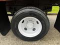A close-up of a Michelin tire mounted on a 2008 Ford F-750 with silver wheel rims and a detailed tread pattern