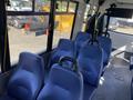 Interior view of a 2017 Chevrolet Express showing blue upholstered seats arranged in a row with safety handles