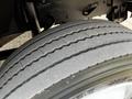 Close-up of a tire from a 1994 Freightliner FL80 featuring distinct tread patterns and sidewall markings