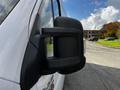 A close-up view of the side mirror of a 2019 RAM Promaster van showcasing its black casing and reflective surface