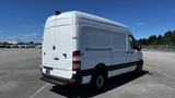 A 2016 Mercedes-Benz Sprinter van in white with a high roof and rear doors visible from the back angle