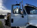 A 2013 International DuraStar 4300 truck with a white exterior and visible side mirror and door details