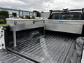 The image shows the bed of a 2011 Ford F-250 SD featuring a diamond plate aluminum toolbox and a clean lined truck bed.