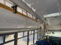 Interior view of a 2017 Chevrolet Express showing the ceiling, grab rails, and a view of the driver's seat and dashboard