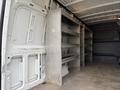 Interior of a 2019 Mercedes-Benz Sprinter with metal shelving units mounted on the walls and an empty cargo space