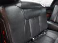 A black leather seat in the interior of a 2008 Cadillac Limousine with a smooth texture and sleek design