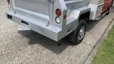 A 2013 RAM 2500 pickup truck with a gray metallic rear bumper and chrome wheels parked on a concrete surface