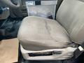 A cloth-covered driver's seat of a 2009 Ford F-450 SD with a slight wear mark on the cushion