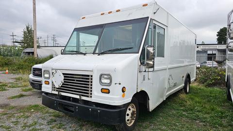 A white 2006 Ford Econoline cargo van with a boxy design and front grille visible