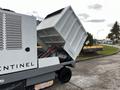 A 2007 Tennant Sentinel with its hopper raised displaying the interior and hydraulic lifting mechanism