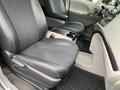 Interior of a 2013 Toyota Sienna featuring black leather seats a central console and cup holders