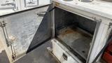 A 2000 Service Deck 9 Foot with an open compartment revealing a metal interior showing some signs of wear and rust