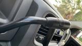 Close-up of a gear shift lever in a 2013 RAM 2500 interior showing the textured grip and control buttons