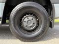 A close-up of a black tire mounted on a gray wheel with the Mercedes-Benz logo in the center
