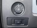 Control panel for lights in a 2013 Ford F-150 featuring a dial and a switch