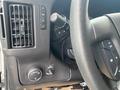 Interior controls and dashboard features of a 2012 Chevrolet Express including air vents and various buttons for settings and adjustments