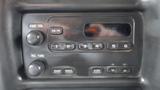 Dashboard audio control panel of a 2008 Chevrolet C7500 featuring knobs for power volume tuning and six preset buttons for radio stations