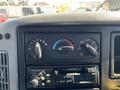 Dashboard controls of a 2007 International 7300 featuring climate settings and a radio system with knobs and buttons