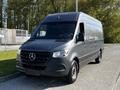 A 2021 Mercedes-Benz Sprinter van in a dark gray color with a sleek design and front grille featuring the Mercedes-Benz emblem