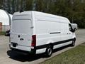 A 2022 Mercedes-Benz Sprinter van is shown in white with a high roof and sliding door on the side, featuring a black stripe along the lower side and rear doors