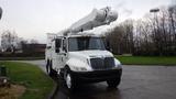 A white 2005 International 4300 bucket truck with a large elevated boom and a utility body for lifting equipment and personnel