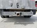 A 2010 Ford F-550 truck's rear view showing the hitch receiver and bumper with some wear and dirt on the surface