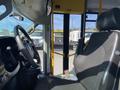 Interior view of a 2017 Chevrolet Express showing the driver's seat and dashboard with steering wheel and control panel